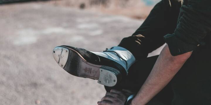 person in black and white nike sneakers